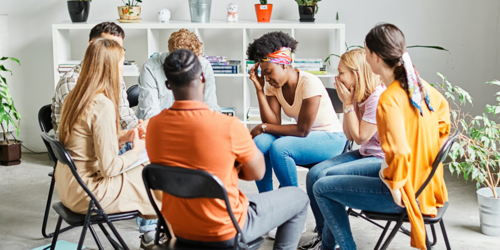 6 people sitting in chairs in a circle position