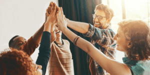 a group of people giving each other high fives